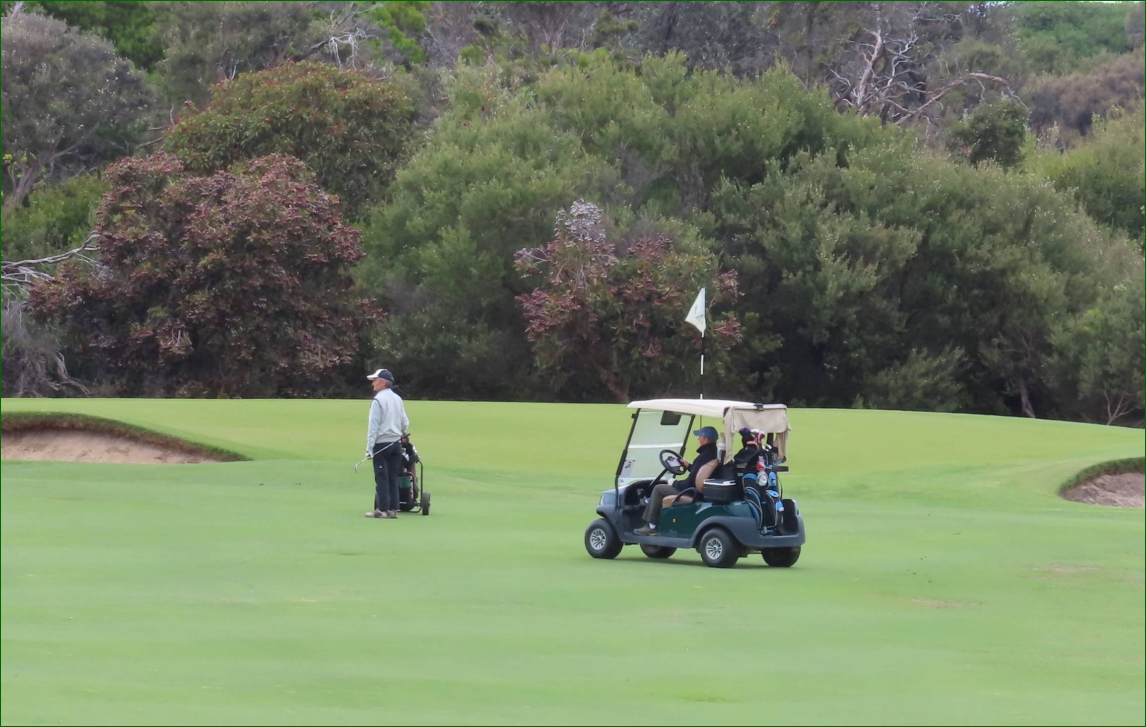 A golf cart on a golf course

Description automatically generated