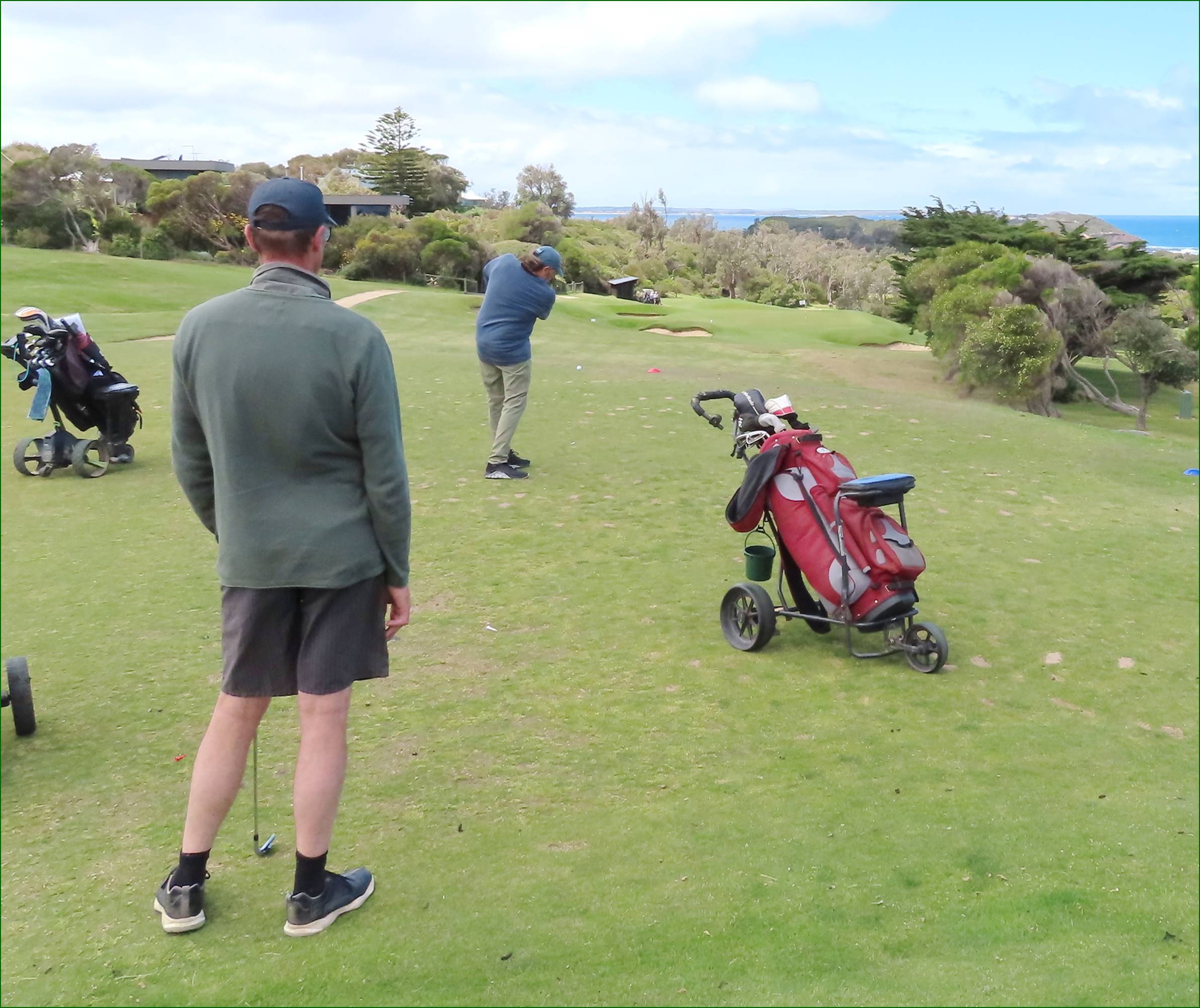 A group of people playing golf

Description automatically generated